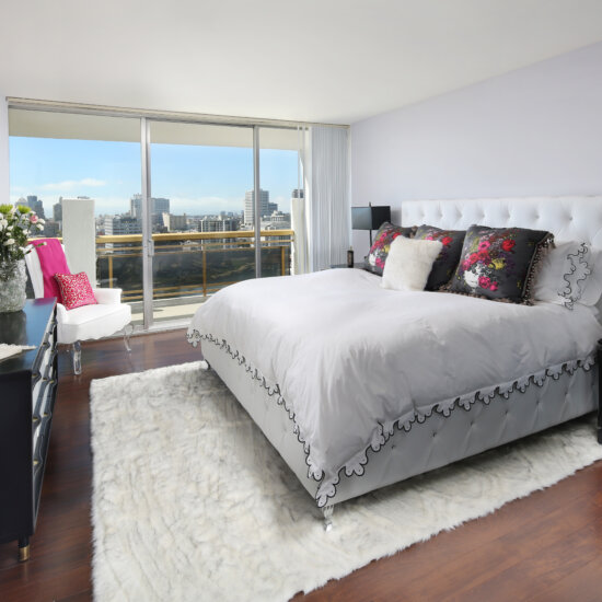 Apartments for Rent in Oakland CA - 1200 Lakeshore - A Bright And Spacious Bedroom With A King Sized Bed, A Huge Window With A Sliding Glass Door That Leads Out To The Balcony, And Hardwood Floors