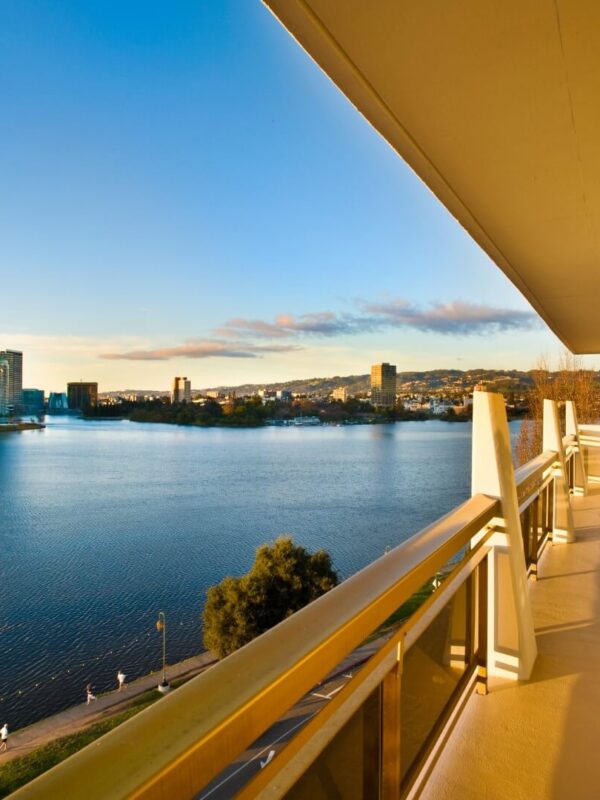 An empty patio at 1200 Lakeshore at sunset with a view across the lake to Oakland, CA.